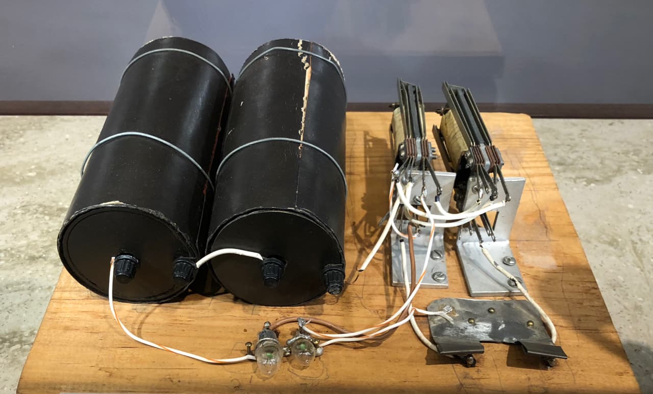 A small wooden box with wires, relay coils, and switches mounted inside, an early electromechanical binary adder.
