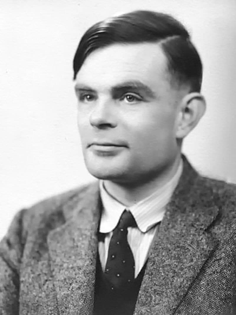 Black-and-white photographic portrait of Alan Turing in 1951, wearing a jacket and tie.