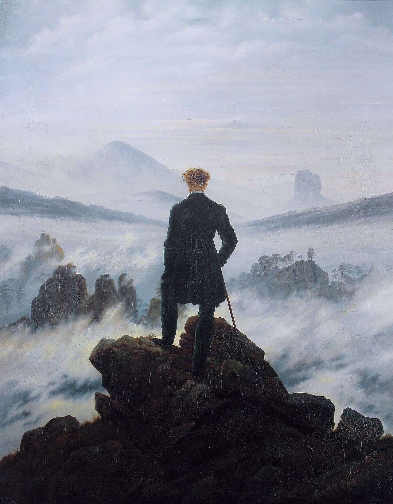 A painting of a man standing on a rocky outcrop, seen from behind, looking out over a vast sea of fog and distant mountain peaks.