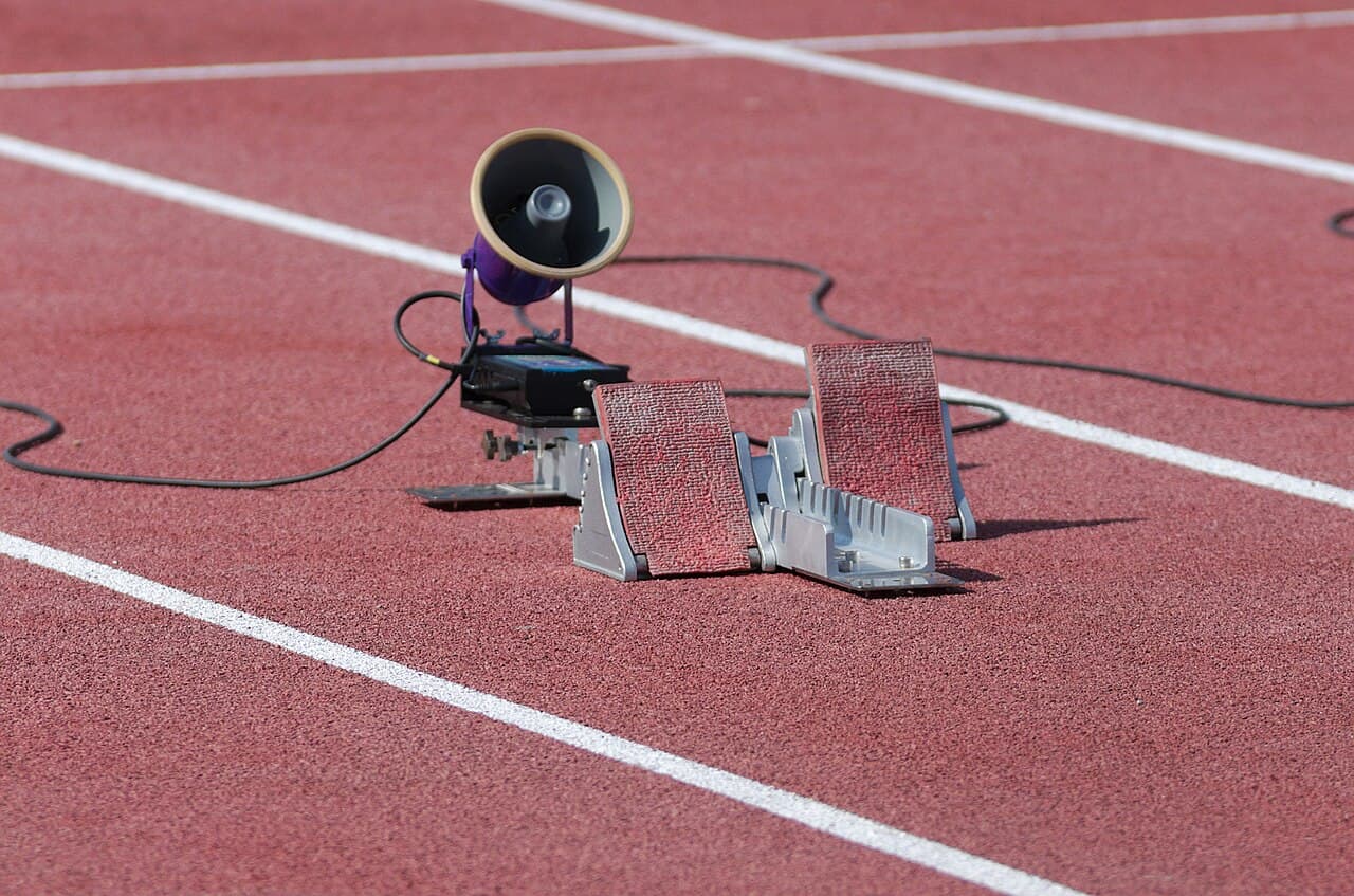 Starting blocks on a running track at the 2013 IPC Athletics World Championships, with a small speaker unit behind them
