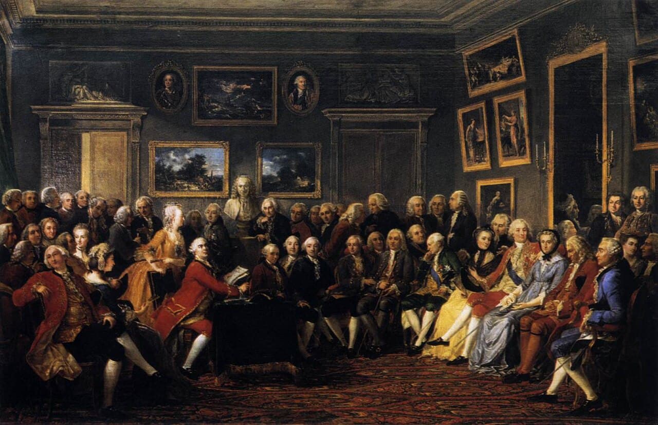 A painted scene of a crowded 18th-century Parisian salon, with a woman hosting a seated audience of men listening to a reading.